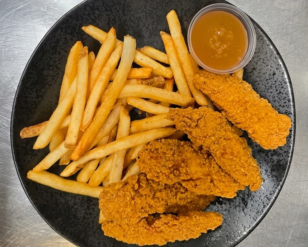 Crispy chicken tenders with fries and plum sauce at Binge Pizza, Calgary
