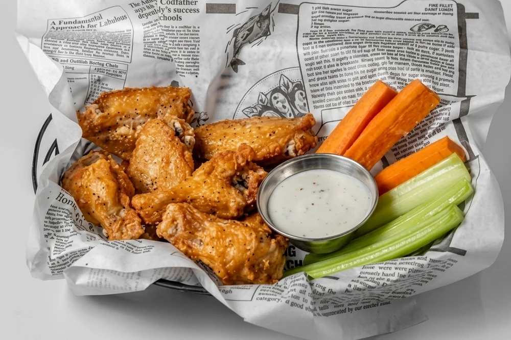A pound of crispy chicken wings served with dip from Binge Pizza in southeast Calgary